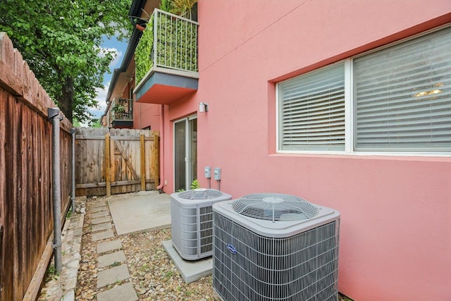 1422 Collier St Unit 102, Austin, TX 78704 - exterior view of central AC unit, stucco siding, and a gate