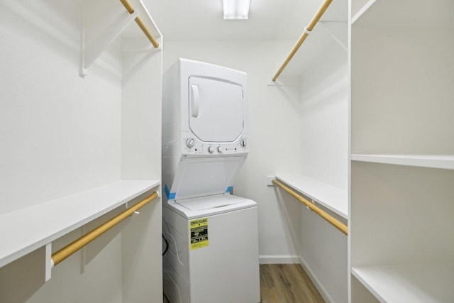 1422 Collier St Unit 102, Austin, TX 78704 - washroom featuring stacked washer / dryer and light wood-style flooring
