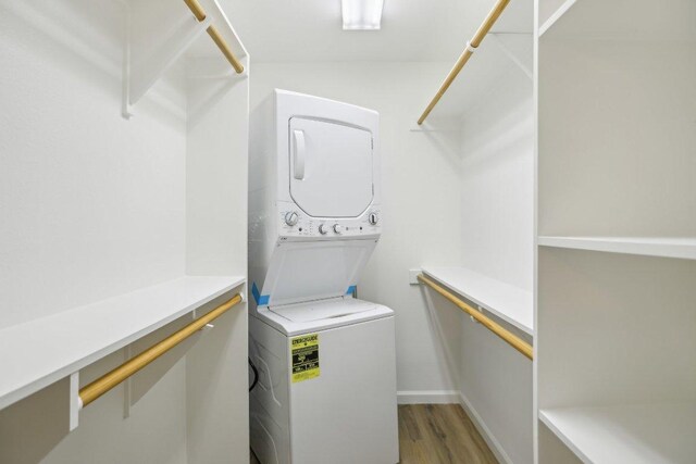 1422 Collier St Unit 102, Austin, TX 78704 - laundry room with stacked washing machine and dryer and light wood-type flooring