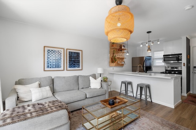 1422 Collier St Unit 102, Austin, TX 78704 - living room featuring wood finished floors and baseboards