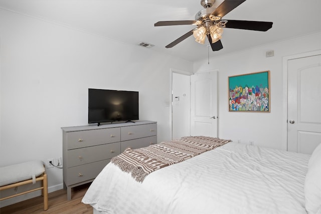 1422 Collier St Unit 102, Austin, TX 78704 - bedroom with wood finished floors, ornamental molding, a ceiling fan, and baseboards