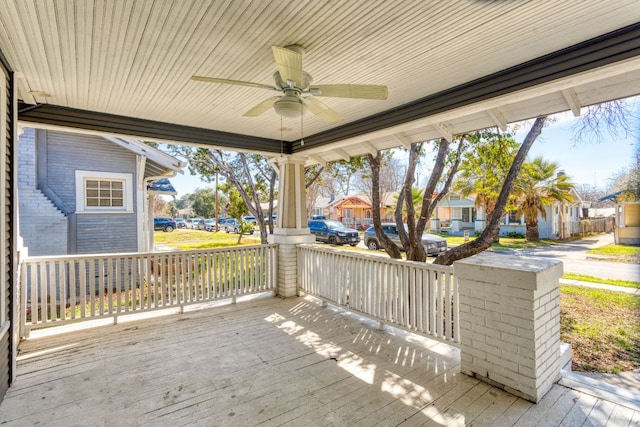 exterior space with a ceiling fan, a residential view, and a porch