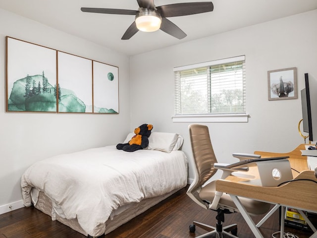 bedroom with a ceiling fan, baseboards, and dark wood-style flooring