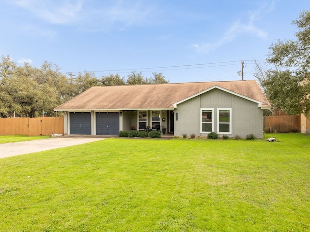 single story home with a garage, fence, concrete driveway, and a front yard