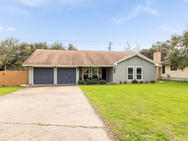 ranch-style house with a garage, concrete driveway, fence, a front yard, and brick siding