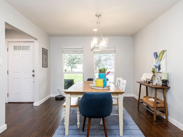 dining room featuring baseboards, a chandelier, and dark wood-type flooring