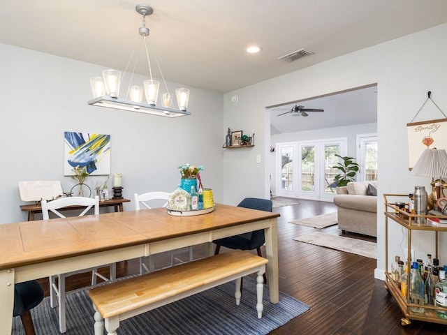 dining space featuring recessed lighting, ceiling fan with notable chandelier, visible vents, french doors, and dark wood-style floors