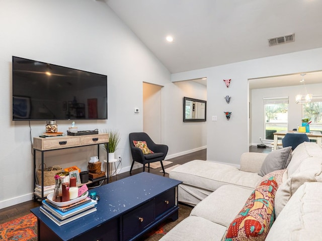 living room featuring baseboards, visible vents, dark wood-type flooring, an inviting chandelier, and vaulted ceiling