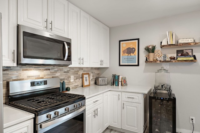 2101 Falcon Hill Dr, Austin, TX 78745 - kitchen with appliances with stainless steel finishes, decorative backsplash, and white cabinets