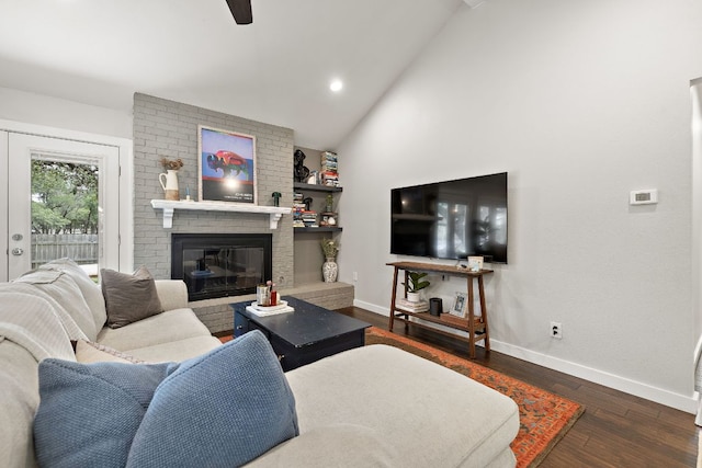 2101 Falcon Hill Dr, Austin, TX 78745 - living room with baseboards, vaulted ceiling, a brick fireplace, a ceiling fan, and dark wood-style flooring