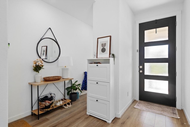 entrance foyer with light wood-style flooring and baseboards