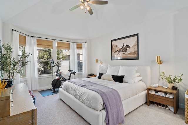 bedroom featuring a ceiling fan, light carpet, vaulted ceiling, and baseboards