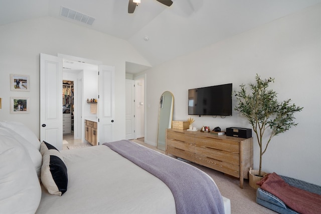 bedroom with visible vents, a spacious closet, a ceiling fan, light carpet, and vaulted ceiling