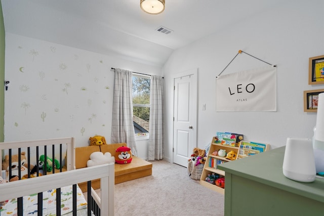 carpeted bedroom featuring lofted ceiling, visible vents, and wallpapered walls