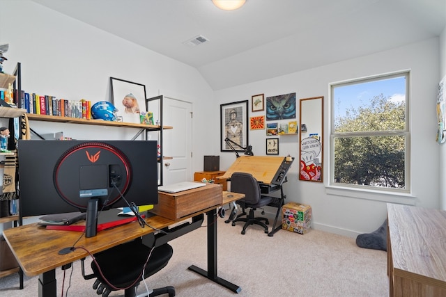 carpeted office with lofted ceiling, baseboards, and visible vents