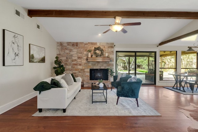 living area with lofted ceiling with beams, wood finished floors, visible vents, and baseboards