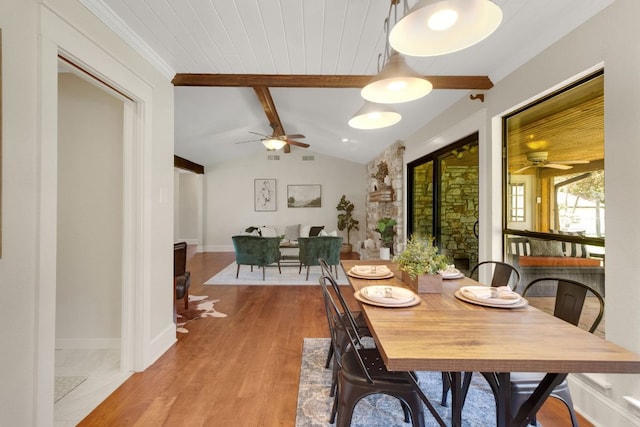 dining area with vaulted ceiling with beams, wood finished floors, a ceiling fan, and baseboards