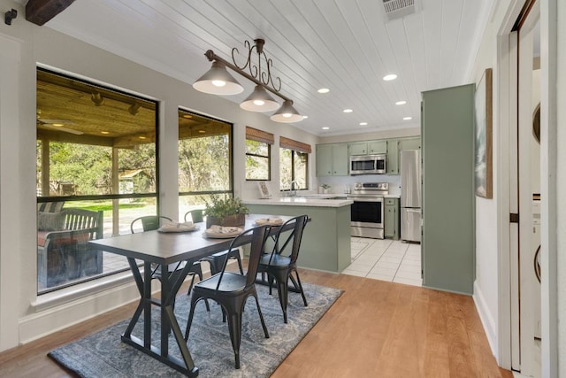 dining space featuring wooden ceiling, recessed lighting, visible vents, ornamental molding, and light wood finished floors