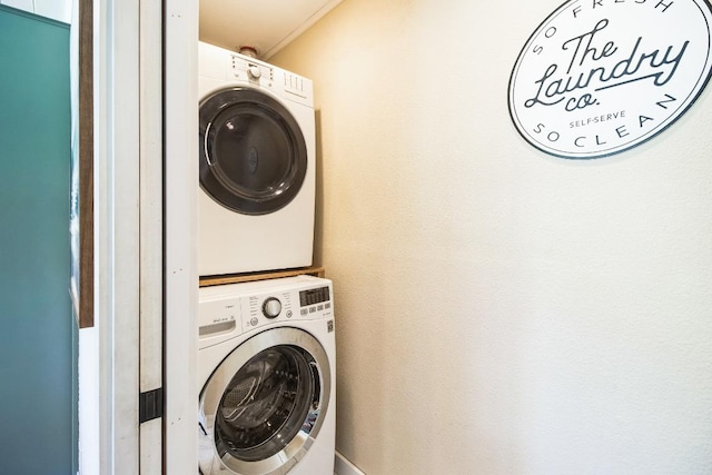 laundry room with stacked washer / dryer and laundry area