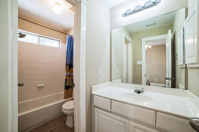 bathroom featuring visible vents, toilet, shower / bath combo, vanity, and tile patterned flooring