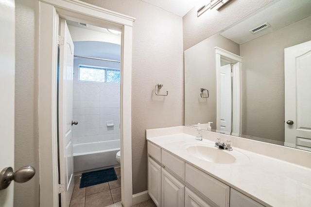 bathroom with visible vents, toilet, tile patterned flooring, vanity, and shower / washtub combination