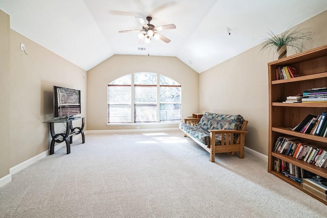 living area with lofted ceiling, visible vents, carpet flooring, ceiling fan, and baseboards