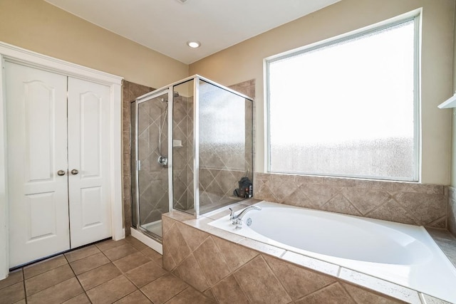 bathroom with tile patterned floors, a shower stall, and a bath