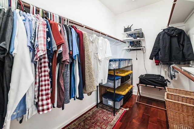 walk in closet with wood finished floors