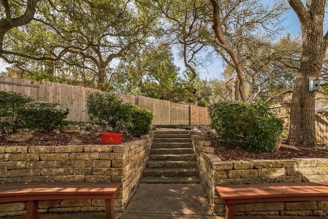 view of yard featuring a fenced backyard and stairway