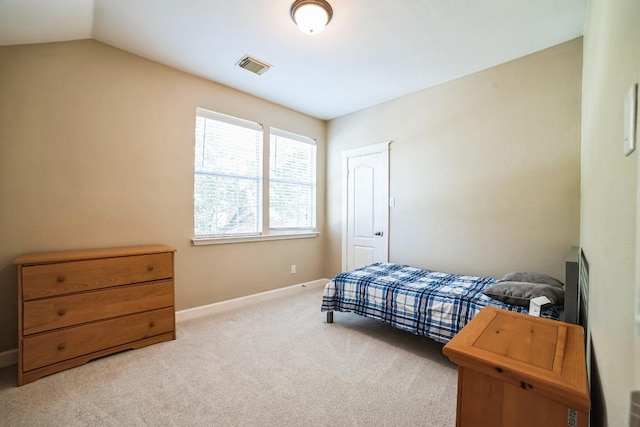 carpeted bedroom with vaulted ceiling, visible vents, and baseboards