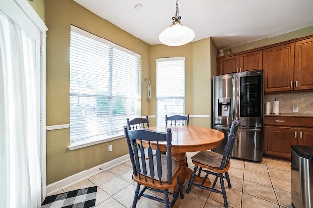 dining room featuring light tile patterned floors and baseboards