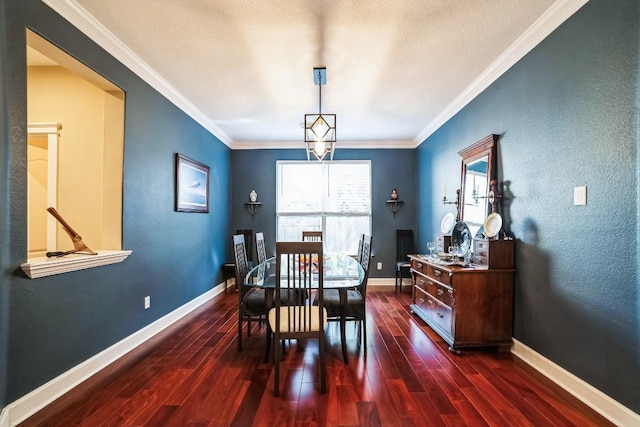 dining space featuring crown molding, wood finished floors, and baseboards