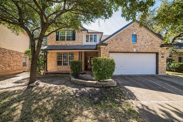 traditional home with driveway, a shingled roof, a garage, and brick siding