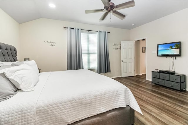 bedroom featuring lofted ceiling, ceiling fan, baseboards, and wood finished floors