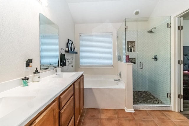 bathroom with double vanity, a sink, a shower stall, tile patterned flooring, and a bath