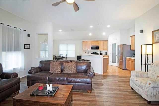 living room with baseboards, light wood finished floors, a ceiling fan, and recessed lighting