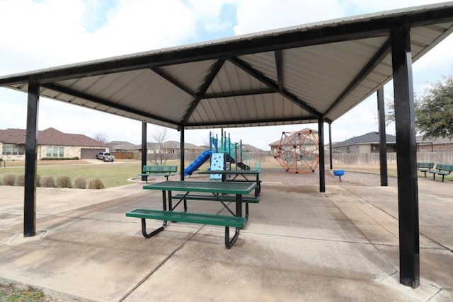 view of home's community featuring playground community and fence