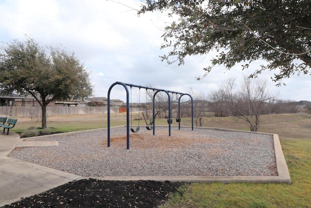 community jungle gym featuring fence