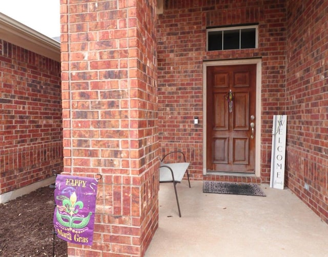 entrance to property with brick siding