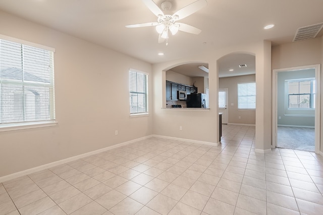 spare room featuring light tile patterned floors, visible vents, recessed lighting, and baseboards