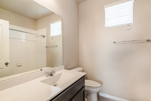 bathroom featuring baseboards, toilet, tile patterned floors, vanity, and a shower