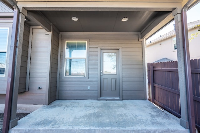 view of exterior entry featuring fence