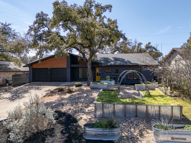 view of front of house featuring concrete driveway and an attached garage