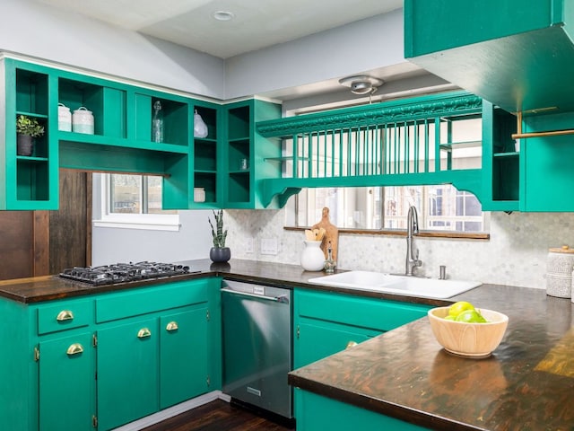 kitchen with open shelves, stainless steel dishwasher, dark countertops, and a sink