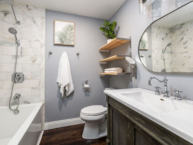 bathroom with toilet, baseboards, wood finished floors, and vanity