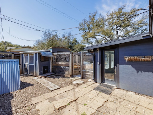 view of patio / terrace with an outbuilding, a storage shed, and fence