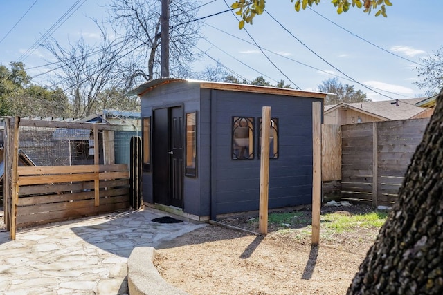 view of outdoor structure featuring an outbuilding and a fenced backyard