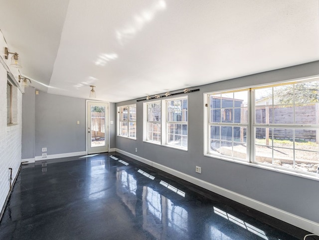 unfurnished room featuring baseboards