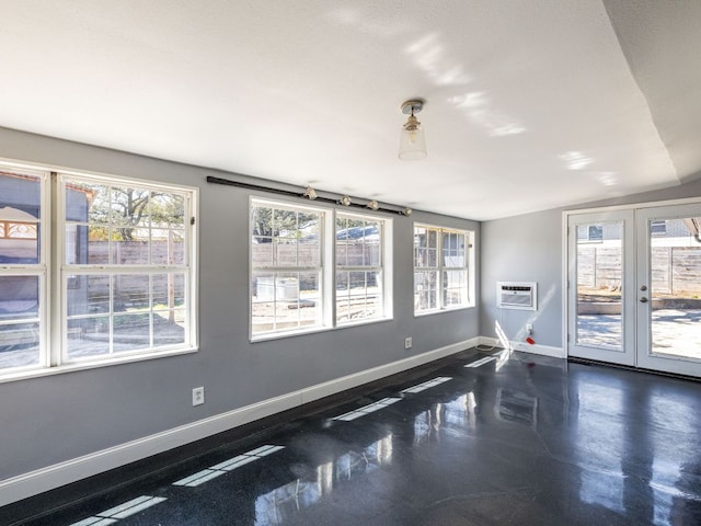 spare room with french doors, baseboards, and a wall mounted AC