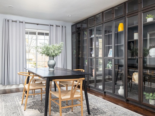 dining area featuring dark wood-type flooring